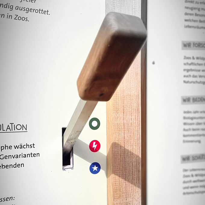 Close-up of an interactive wooden lever