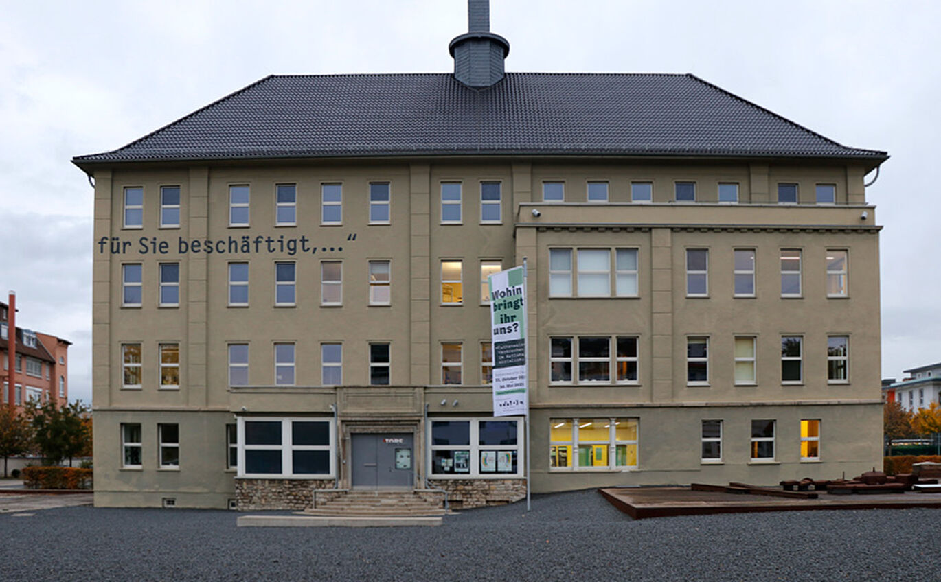 Exterior view of the museum with flag in the corporate design