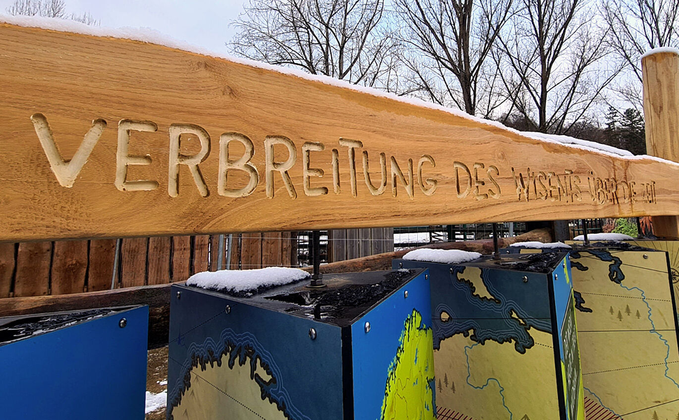 Close-up of a lettering milled into wood "Spread of the bison over time"