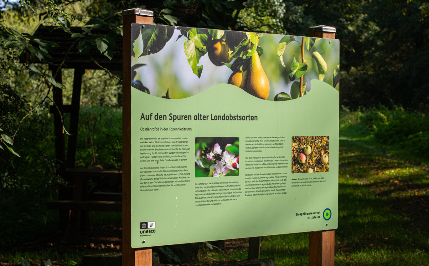 Green outdoor information board provides information about the country fruit varieties