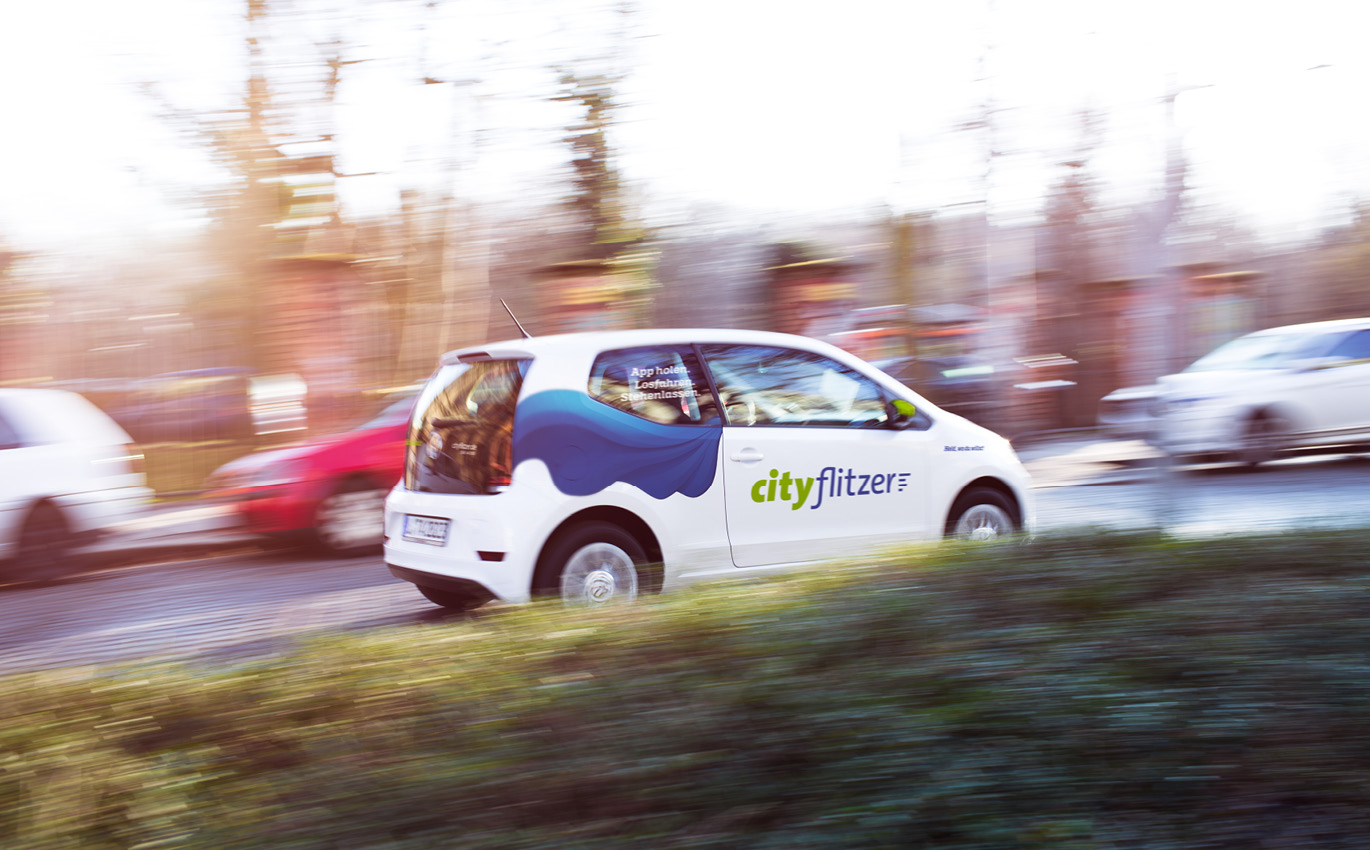 Printed cityflitzer car in corporate design in motion 